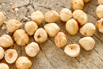Hazelnuts on rough wooden background.