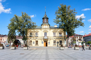NOWY TARG, POLAND - SEPTEMBER 12, 2019: City hall building and fountain in front of it at the...