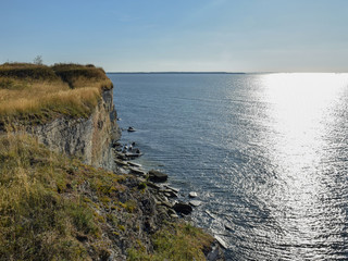 sea landscape with rocky cliff, blue sea and sky