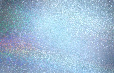 Spectrum light on glitz blue texture. Frosted glitter background. Winter festive fabolous abstraction.