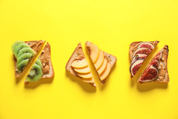 Tasty sweet sandwiches on color background