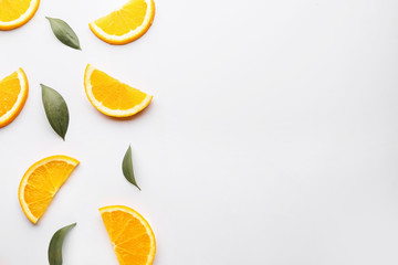 Fresh orange slices with leaves on white background