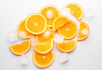 Fresh orange slices with ice cubes on white background
