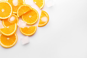 Fresh orange slices with ice cubes on white background