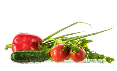 fresh vegetables with drops of water on a white background, poidor, cucumber, bell pepper, onion, greens