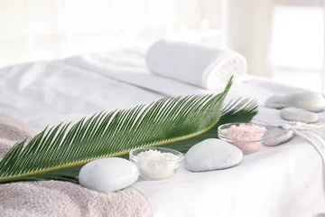 Fotobehang Sea salt with spa stones and tropical leaf in beauty salon © Pixel-Shot