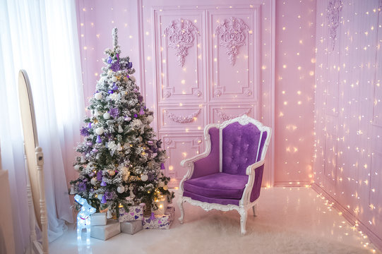 New Year's Interior With Purple Sofa Close-up And Copy Space. Living Room With Sofa And Christmas Tree For Neon Colors.