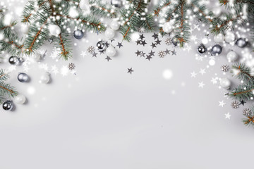Christmas winter composition with fir branches tree, white, silver balls on pastel light background. Merry Xmas card. Holiday time. Happy New Year. Space for text. View from above, flat lay.