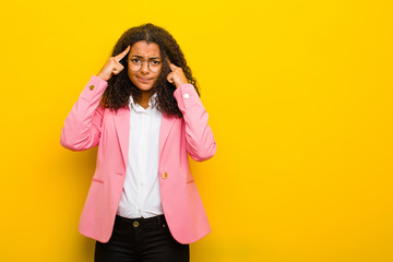 black business woman with a serious and concentrated look, brainstorming and thinking about a...