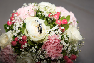 wedding rings close up on bouquet flowers marriage