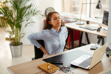Young businesswoman having backache