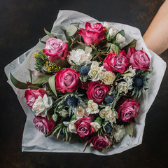 flower bouquet with pink roses, blue thistle, mimosa and white roses