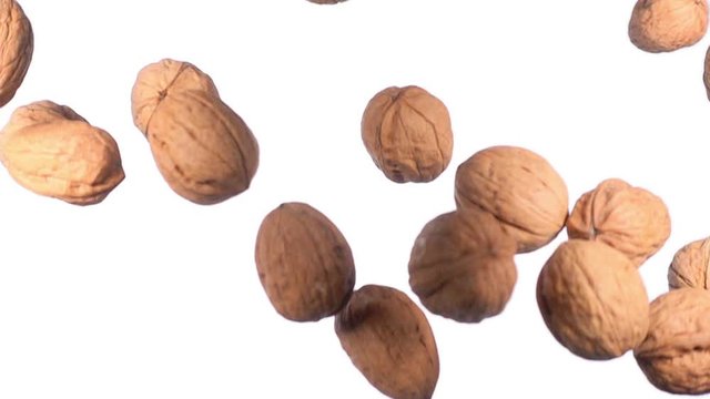 walnuts flying in super slow motion isolated on white background