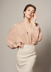 Fashion Portrait Of Beautiful Luxury Woman With Jewelry. Photo of young woman wearing shiny necklace and earrings.