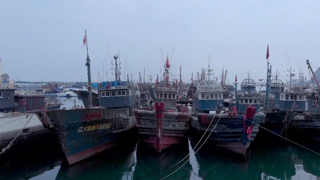 Drone shot of wooden chinese boats with morning fog Dalian, China, 19-6-19