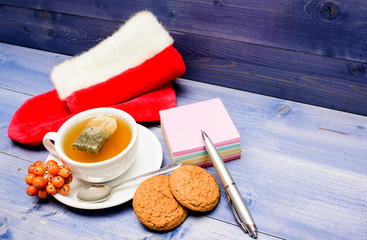 Cup of tea on blue background close up. Gourmet delicious taste. Berry tea. Warm beverage. Drink aromatic rowanberry beverage. Health care folk remedies. Ceramic cup hot fresh brewed tea beverage
