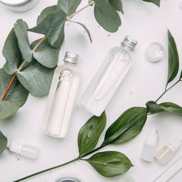 Bottle of natural cosmetics Flatley. Ecological cosmetics in jars with greens.