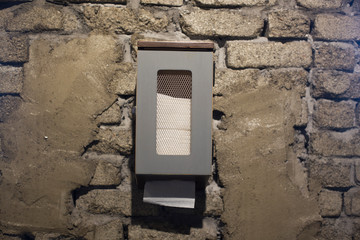 Wall-mounted tissue box on the cement wall