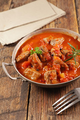 beef stew with tomato sauce and herbs