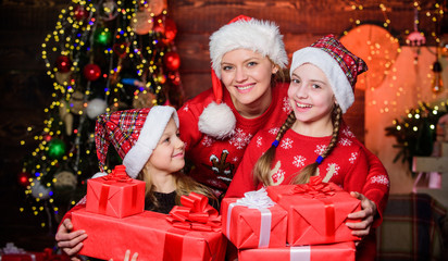 Fototapeta na wymiar The start of the new year. Mother and daughters on Christmas day. Mother and children with Christmas gifts. Happy family celebrate new year and Christmas. New year party. Happy new year