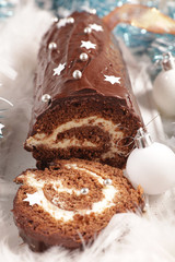 christmas yule log and decoration- festive chocolate pastry with cream