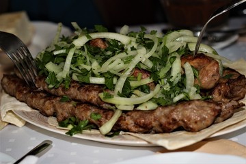juicy kebab on a white plate