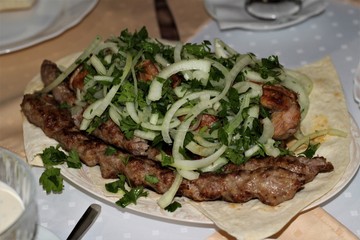 juicy kebab on a white plate