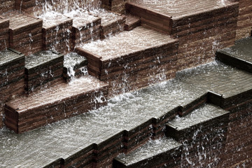 Artificial waterfall made of bricks in the city