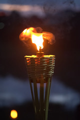 Bamboo torches oil lamp with bokeh at night