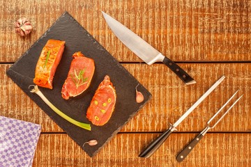 Cutting raw pork chops. Marinated meat. Preparing for barbecue. Home preparation of pork. Pork chop...