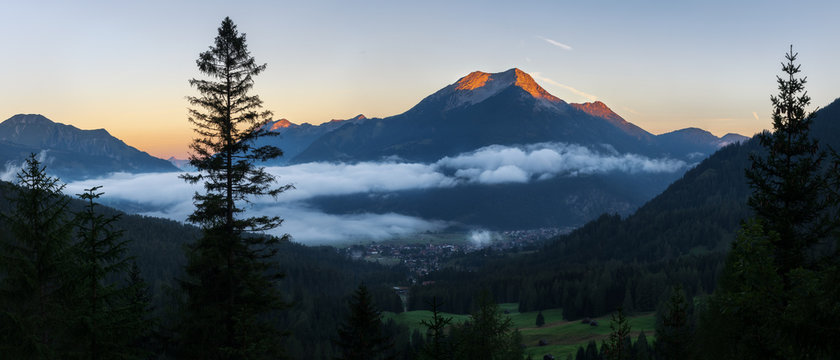 Seebensee reflection with Vorderer Drachenkopf mountain and coburger hut at sunrise