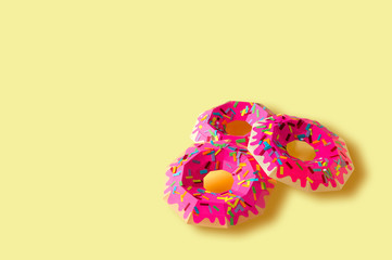 Paper donuts on yellow background