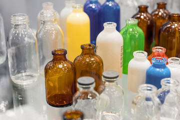 Many glass and plastic bottles. Bottles for chemicals, medicines and pharmaceuticals.