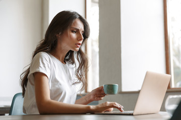 Woman indoors at home using laptop computer