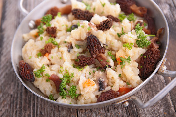 mushroom risotto and herbs in pan
