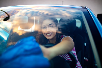 Cleaning car interior. Woman with microfiber cloth cleaning car. Young woman, driver, dry wiping her car with microfiber cloth, cleaning auto.