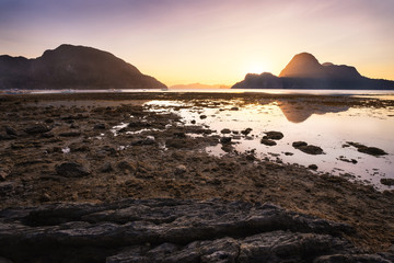 Sunset on El Nido village with silhouette of tropical islands in background. Palawan, Philippines