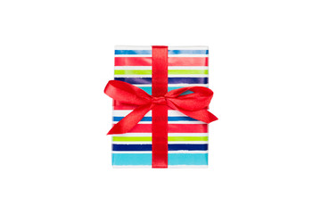 Fototapeta premium Christmas or other holiday handmade present in colored paper with red ribbon. Isolated on white background, top view. thanksgiving Gift box concept