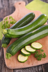 raw zucchini on wooden board