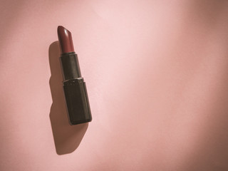 Woman lipstick on pink background with copy space