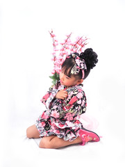 asian little girl  Wearing yukata Holding flowers on white backgound
