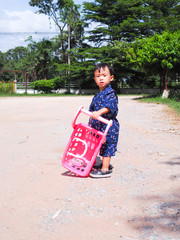 asian little  boy  Wearing yukata with cart