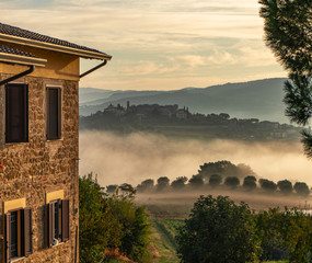 dawn rural landscape with light fog. Italy sunrise panorama. country house.