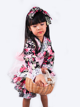 asian little girl  Wearing yukata with fruit basket on white backgound