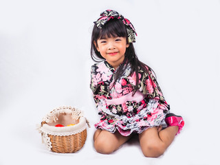 asian little girl  Wearing yukata with fruit basket on white backgound