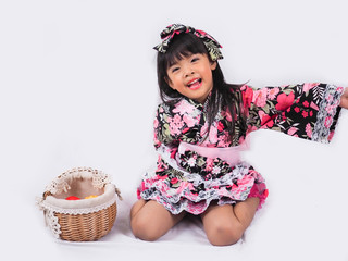 asian little girl  Wearing yukata with fruit basket on white backgound