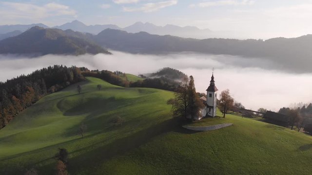 Autumn aerial view of a beautiful church on the top of a hill, in Slovenia