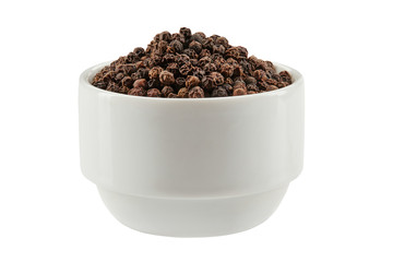 Black peppercorns in a bowl isolated on white background with copy space for text or images. Spices and herbs. Packaging concept. Close-up.