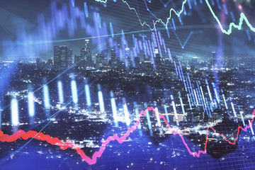 Financial graph on night city scape with tall buildings background multi exposure. Analysis concept.