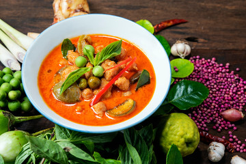  Popula Thai  food  Red Curry Chicken with ingredients  on  wood background. ,Thai name kang pad, spicy curry